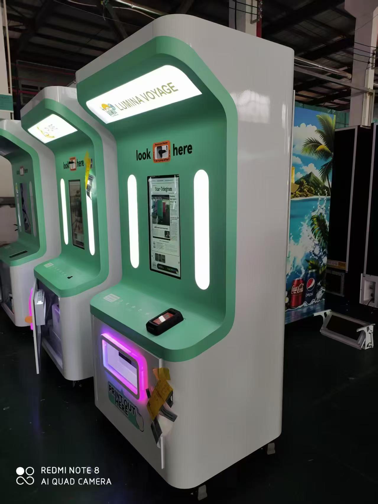 Two green Lumina Voyage newspaper photo booths
